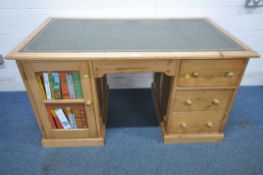 A 20TH CENTURY PINE DESK, with a green leather writing surface, fitted with three assorted