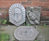 THREE CONCRETE GARDEN PLAQUES, one featuring a roaring lion, a gauntlet and an African lady in the