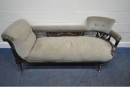 AN EDWARDIAN MAHOGANY FRAMED SOFA, one end scrolled, the other mimicking a chair, scrolled and