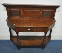 AN EARLY 20TH CENTURY OAK SIDE TABLE, with a raised back, atop a base with canted corners, and a