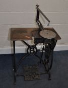 A BRADBURY AND CO. OF OLDHAM, TREADLE SCROLL SAW, with a cast iron base and wooden top total
