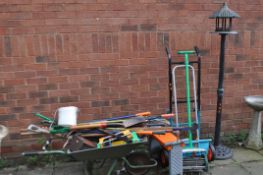 A COLLECTION OF GARDEN TOOLS, including a wheelbarrow, a plastic bird house on stand, a kneeler, etc