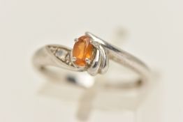 A 9CT WHITE GOLD GEM SET RING, set with an oval cut Citrine, four claw set and flanked with a