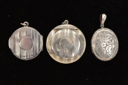 THREE SILVER AND WHITE METAL LOCKETS, the first a circular form compact style locket with engine
