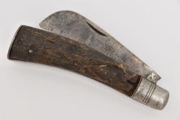 A FLAT CAP PRUNING KNIFE, fitted with an AF antler handle, blade signed 'Real Witness Knife', open