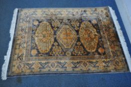 A RECTANGULAR WOOLLEN RUG, with three central medallions, repeating patterns, surrounded by a