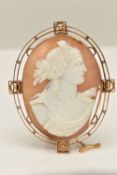 A ROSE METAL CAMEO BROOCH, of an oval form, carved shell cameo depicting a lady in profile, collet
