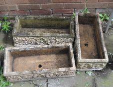 THREE RECTANGULAR CONCRETE PLANTERS, all 55cm long with rose detailing to each facet