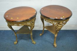 A PAIR OF GOLD PAINTED CAST IRON PUB TABLES, with a stained wood surface, raised on shaped legs with