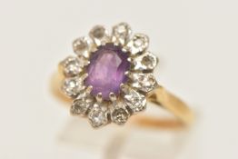 AN 18CT GOLD AMETHYST AND DIAMOND CLUSTER RING, of an oval form, set with a central oval cut