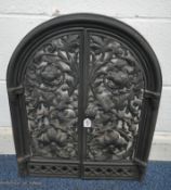 A CAST IRON ARCHED FIRE FRONT, the double doors with pierced foliate details, width 52cm x height
