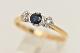 AN 18CT GOLD SAPPHIRE AND DIAMOND THREE STONE RING, set with a central circular cut deep blue