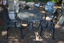 A BLACK CAST ALUMINIUM CIRCULAR GARDEN TABLE, with a lattice detail, diameter 71cm x height 68cm,
