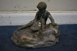 A LEAD GARDEN ORNAMENT, modelled of a putti fishing with a shell on some rocks, width 42cm x depth