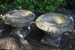 A PAIR OF WEATHERED COMPOSITE CAMPAGNA GARDEN URNS, on a loose square base, diameter 52cn x height