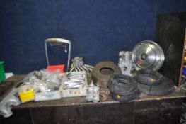 A COLLECTION OF VINTAGE CAR PARTS including four Rover hub caps, a radiator surround, a small single
