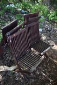 A SET OF FOUR STAINED TEAK FOLDING GARDEN CHAIRS, condition report: solid frames but in need of
