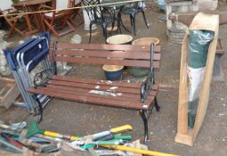 A GARDEN BENCH, 122cm wide with cast iron ends, wooden slatted seat and back, a pair of metal