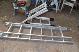 AN ALUMINIUM SHORT DOUBLE EXTENSION LADDER, with six rungs to each 191cm section and a platform