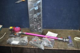 A DYSON V7 CORDLESS VACUUM CLEANER, with charger, accessories and original box (PAT pass and