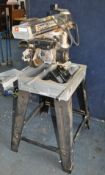 A DeWALT DW1251 RADIAL ARM SAW, with a 10in blade, and stand, total height 138cm (PAT pass and
