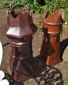 TWO EARLY 20th CENTURY TREACLE GLAZED CHIMNEY POTS, of two different styles the tallest being 97cm
