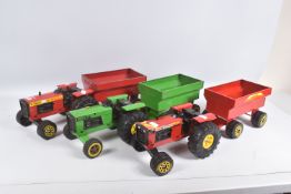 THREE TONKA TOYS FARM TRACTOR AND TRAILERS, two in red livery, the other in green, all appear