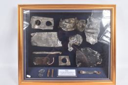 A LARGE FRAMED DISPLAY OF REMAINS OF A SPITFIRE THAT WAS SHOT DOWN DURING WWII, this Mark One