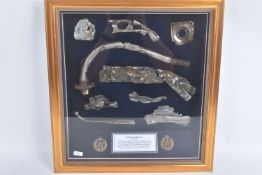 A FRAMED COLLECTION OF REMNANTS OF A HAWKER HURRICANE THAT CRASHED 1940 DURING WWII, the plane was