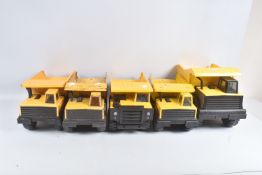 A MIGHTY TONKA TOYS DUMPER TRUCK, with three regular Tonka Toys examples and a similar Matchbox