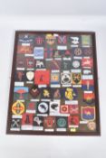 A LARGE GLAZED FRAME CONTAINING OVER 50 EXAMPLES OF WW2 UNIT/FORMATION ARM/SLEEVE PATCHES FROM