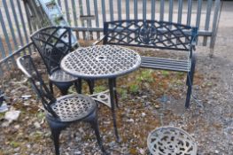 FOUR ITEMS OF CAST ALUMINIUM GARDEN FURNITURE including a round table, a pair of chairs and a bench.