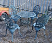 A CAST ALUMINIUM GARDEN TABLE AND FOUR SIMILAR CHAIRS with pierced fretwork 70cm diameter top.