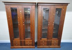 A PAIR OF MODERN PINE DISPLAY CABINETS, with double glass doors, over four drawers, and a single