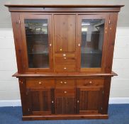 A MODERN PINE DRESSER, fitted with two glass doors, flanking a push to open door, over two