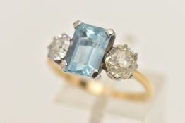 A YELLOW AND WHITE METAL AQUAMARINE AND DIAMOND THREE STONE RING, centring on a rectangular cut