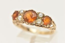 A 9CT GOLD CITRINE AND SEED PEARL RING, set with three circular cut Citrine's, between four small