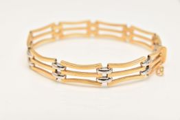 A BI-COLOUR HINGED BANGLE, open work gate style bracelet of yellow and white metal links, fitted