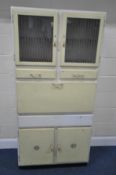 A WHITE AND YELLOW PAINTED KITCHEN QUEEN, fitted with double glass doors, two drawers, a fall