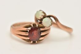 TWO ROSE METAL GEM SET RINGS, the first a Gypsie set oval cut garnet ring, hallmarked 9ct