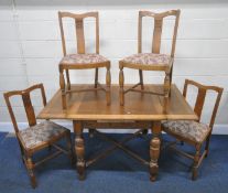 AN EARLY 20TH CENTURY OAK DRAW LEAF DINING TABLE, raised on turned legs, united by a cross