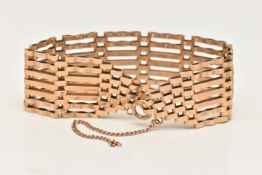 A YELLOW METAL WIDE GATE BRACELET, an AF seven bar gate bracelet, approximate width 23mm,