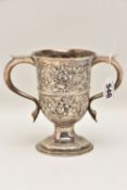 A GEORGE III SILVER TROPHY CUP, a later added repousse decorated trophy cup with loop handles and