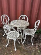 A PAINTED CAST ALUMINIUM GARDEN TABLE, diameter 58cm x height 67cm, and four chairs, condition