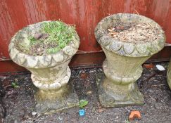 A PAIR OF CONCRETE PLANTERS, with fluted flower petals, both sat on integrated square bases, heights