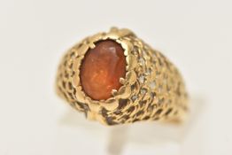 AN 18CT GOLD CITRINE RING, set with an oval cut Citrine, claw setting (claws are wearing thin), to