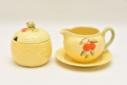 A VINTAGE HONEY POT AND JUG DECORATED WITH CHERRIES in relief style decoration, the honey pot with a
