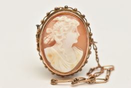 A YELLOW METAL SHELL CAMEO BROOCH, of an oval form, carved shell cameo depicting a lady in