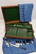 A WOODEN CANTEEN OF SILVER CUTLERY, a twelve person setting of rat tail pattern forks and spoons