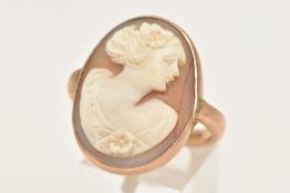 A ROSE METAL CAMEO RING, of an oval form, collet set with a carved shell cameo depicting a lady in